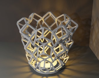 Puede incluir: Una lámpara geométrica blanca con una luz en su interior, proyectando un cálido resplandor. La lámpara está hecha de una serie de cuadrados interconectados y está diseñada para crear un aspecto único y moderno.
