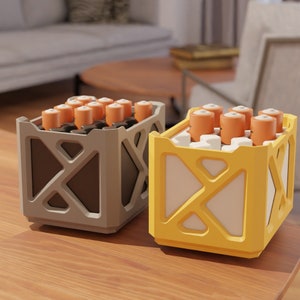 May include: Two battery storage containers, one gray and one yellow, with multiple batteries inside. The containers have a grid pattern on the front.