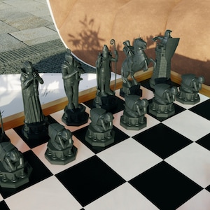 May include: A black and green chess set with various pieces arranged on a black and white chessboard. The pieces include a king, queen, knight, bishop, rook, and pawn. The chessboard is made of wood and has a polished finish.