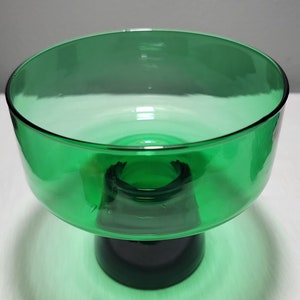May include: A green glass pedestal bowl with a wide, shallow bowl and a thick, round base.