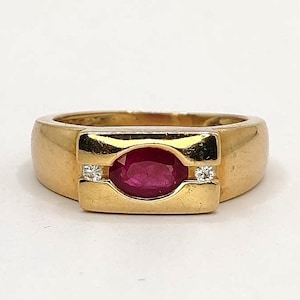 18K yellow gold bangle ring set with an oval ruby and diamonds