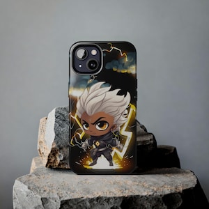 May include: Black iPhone case with a cartoon illustration of a character with white hair and a black outfit, surrounded by yellow lightning bolts against a dark blue and black background.