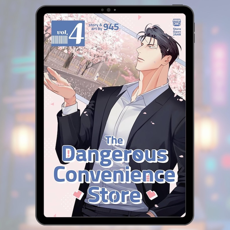 May include: A digital tablet displays the cover art for "The Dangerous Convenience Store," Vol. 4. The image features a man in a suit with the title text in a blue and white font. The background shows a cherry blossom scene.