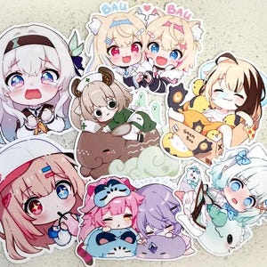 May include: A collection of anime-style stickers featuring various characters with large eyes and colorful hair. The stickers showcase different poses and expressions, with some holding objects or interacting with each other. The stickers are die-cut and have a white border.