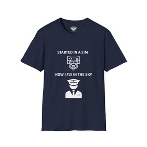 navy colored shirt with the text Started in a Sim Now I Fly in the Sky Shirt has a picture of a computer monitor with a yoke in front of it and an airline captain pilot