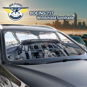 Puede incluir: Un parasol para parabrisas de coche negro con una imagen de la cabina de un Boeing 737. El parasol tiene el texto "BOEING 737 Windshield Sunshade" y un logotipo con el texto "ERIC FLIGHT AVIATION DESIGNS".