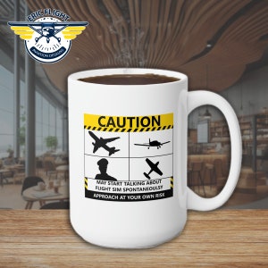 May include: White ceramic coffee mug with a black handle. The mug features a yellow and black caution sign with a silhouette of a pilot and aeroplanes. The text on the sign reads "CAUTION. MAY START TALKING ABOUT FLIGHT SIM SPONTANEOUSLY. APPROACH AT YOUR OWN RISK."