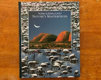 May include: A book cover featuring a photograph of a flock of flamingos in a body of water with red rock formations in the background. The book title is "Nature's Masterpieces" and the subtitle is "The Earth, Its Wonders, Its Secrets". The book is published by Reader's Digest.