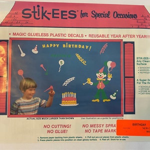 May include: A colorful birthday party decoration set with a clown, balloons, and a cake. The set is made of reusable, glue-less plastic decals. The package includes instructions for use and a new code number 801.