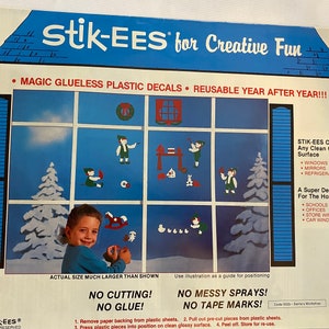 May include: A colorful illustration of a house with windows and a Christmas wreath on the door. The illustration is surrounded by a blue border and the text "stik-EES for Creative Fun" is at the top. The text "MAGIC GLUELESS PLASTIC DECALS REUSABLE YEAR AFTER YEAR!!!" is below the illustration. The text "STIK-EES Cling To Any Clean Glossy Surface" is on the right side of the illustration. The text "WINDOWS MIRRORS REFRIGERATORS" is below the text "STIK-EES Cling To Any Clean Glossy Surface". The text "A Super Decoration For The Home" is below the text "REFRIGERATORS". The text "SCHOOLS OFFICES STORE WINDOWS CAR WINDOWS" is below the text "A Super Decoration For The Home". The text "ACTUAL SIZE MUCH LARGER THAN SHOWN" is at the bottom of the illustration. The text "NO CUTTING! NO GLUE!" is below the text "ACTUAL SIZE MUCH LARGER THAN SHOWN". The text "NO MESSY SPRAYS! NO TAPE MARKS!" is below the text "NO CUTTING! NO GLUE!". The text "Code 000-Santa's Workshop" is below the text "NO MESSY SPRAYS! NO TAPE MARKS!". The text "1. Remove paper backing from plastic sheets. 2. Pull out pre-cut pieces from plastic sheets. 3. Press plastic pieces into position on clean glossy surface. 4. Peel off. Store for re-use." is below the text "Code 000-Santa's Workshop".