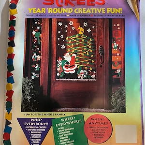 May include: A colorful Christmas-themed Stik-Ees reusable sticker set featuring a Santa Claus, a Christmas tree, and other holiday decorations. The set is designed for use on windows, mirrors, and other smooth surfaces. The product is called "Classic Christmas" and has the code 972.
