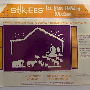 May include: A purple and white illustration of a nativity scene with a star and a comet in the sky. The text on the image reads "Stik-EES for Your Holiday Windows", "Magic Glueless Plastic Decals", "Reusable Year After Year!!!", "STIK-EES Cling To Any Clean Glossy Surface", "Windows, Mirrors, Refrigerators", "A Super Decoration For The Home", "Schools, Offices, Store Windows, Car Windows", "Actual Size Much Larger Than Shown", "No Cutting! No Glue!", "No Messy Sprays! No Tape Marks!", "Code W: Bethlehem Stable Scene", "Remove paper backing from plastic sheets. Pull out pre-cut pieces from plastic sheets. Press plastic pieces into position on clean glossy surface. Peel off. Store for re-use."