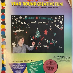 May include: A package of reusable Christmas and New Year's themed stickers. The stickers feature a variety of holiday imagery, including a Christmas tree, snowflakes, a snowman, and a reindeer. The package is labeled "Stik-Ees Year 'Round Creative Fun!" and "Giant Christmas Code 432".