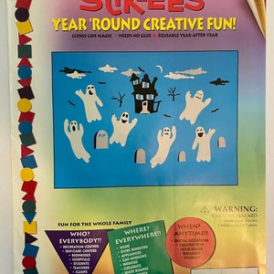 May include: A colorful illustration of a haunted house with ghosts and bats. The text "Stik-Ees Year 'Round Creative Fun!" is at the top of the image. The text "Fun for the whole family" is at the bottom of the image. The text "Who? Everybody!!" is in a blue triangle. The text "Where? Everywhere!!" is in a blue triangle. The text "When? Anytime!!" is in a blue triangle. The text "Boooooville Code 326" is at the bottom of the image. The text "Product Size Much Larger Than Shown" is at the bottom of the image.