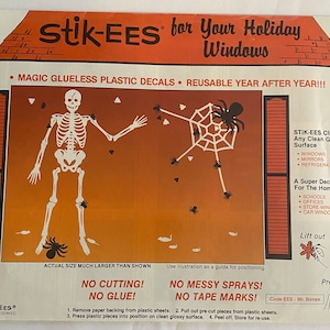 May include: A set of reusable Halloween window clings featuring a skeleton and a spider web with spiders. The clings are made of plastic and are designed to stick to any clean, glossy surface. The image includes the text "Stik-EES for Your Holiday Windows" and "Magic Glueless Plastic Decals Reusable Year After Year!!!".