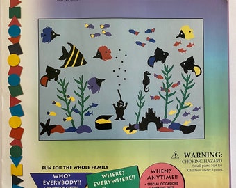 May include: A colorful set of reusable, no-glue, Stik-Ees stickers featuring tropical fish, a seahorse, and a castle. The stickers are designed for use in homes, businesses, schools, and more. The package includes the text "Stik-Ees Year 'Round Creative Fun!" and "Tropical Fish Code 709".