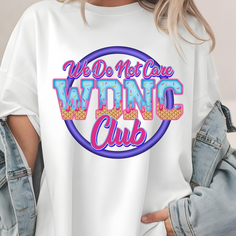 May include: White t-shirt with a colorful graphic. The design features the text "We Do Not Care WDNC Club" in a playful font, with the letters styled to resemble ice cream cones. The text is set within a purple circle.