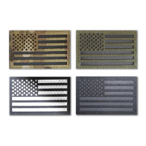 May include: Four different American flag patches. The patches are made of a black, gray, green, and camouflage fabric. The flags are all the same size and have a black outline.