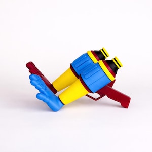 May include: A colorful toy gun with a red handle and blue, yellow, and black details. The toy gun has two barrels and a trigger. The design is playful and eye-catching, perfect for imaginative play.