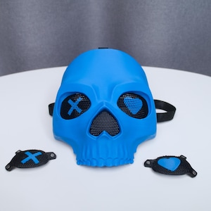 May include: A bright blue skull mask with mesh eye and nose openings. The eyes have an X and heart design. Two additional black eye covers with X and heart designs are included. The mask has a black strap.