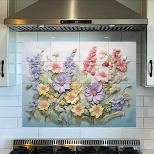 May include: A colorful floral tile backsplash with a 3D effect. The tiles feature a variety of flowers in shades of pink, purple, yellow, and blue. The flowers are arranged in a bouquet-like pattern, with leaves and stems filling in the spaces between them. The tiles are set against a light blue background.