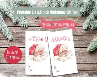 May include: Two printable 2 x 3.5 inch Christmas gift tags featuring a watercolor illustration of Santa Claus with the text "Merry Christmas". The tags have blank spaces for "To:" and "From:".