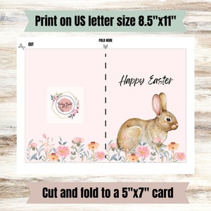 May include: Printable card template featuring a pink background with a watercolor bunny and flowers. The card reads "Happy Easter" and is designed to be cut and folded to create a 5x7 inch card.