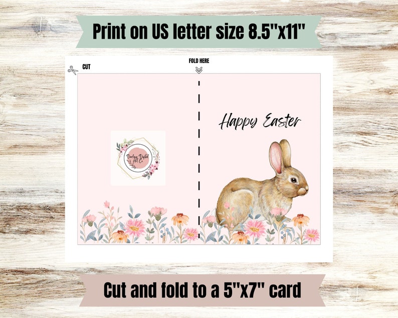 May include: Printable card template featuring a pink background with a watercolor bunny and flowers. The card reads "Happy Easter" and is designed to be cut and folded to create a 5x7 inch card.