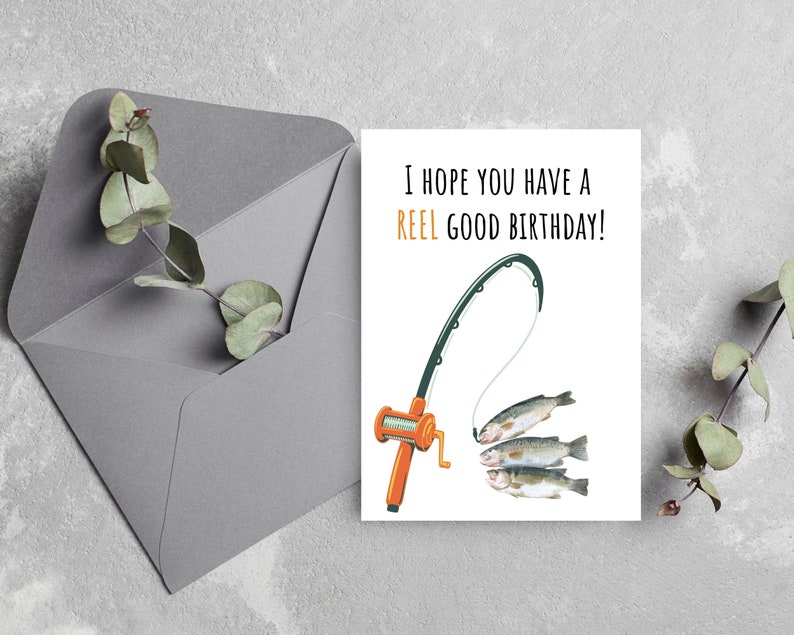 May include: A white card with a fishing rod and three fish on a line. The text on the card reads "I hope you have a REEL GOOD BIRTHDAY!"