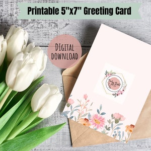 May include: Printable 5"x7" greeting card with a floral design and the text "Darling Printed" in a gold hexagon frame. The card is on a brown envelope and a bouquet of white tulips is in the background.