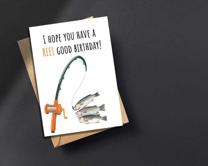 May include: A white card with the text "I hope you have a reel good birthday!" and a cartoon illustration of a fishing rod with three fish on the line.