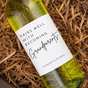 May include: A bottle of white wine with a label that reads "Pairs well with becoming grandparents. Congratulations!"