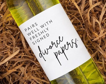 May include: A bottle of white wine with a label that reads "Pairs well with freshly signed divorce papers."