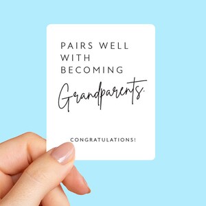 May include: White card with black text that reads "Pairs well with becoming grandparents. Congratulations!"