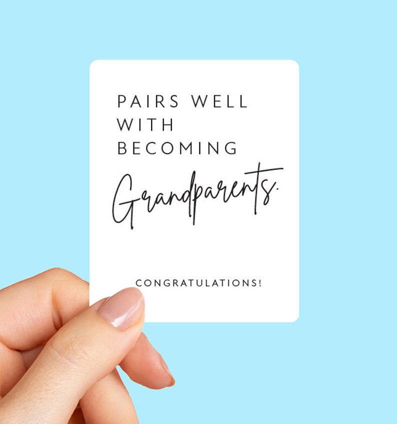 May include: White card with black text that reads "Pairs well with becoming grandparents. Congratulations!"