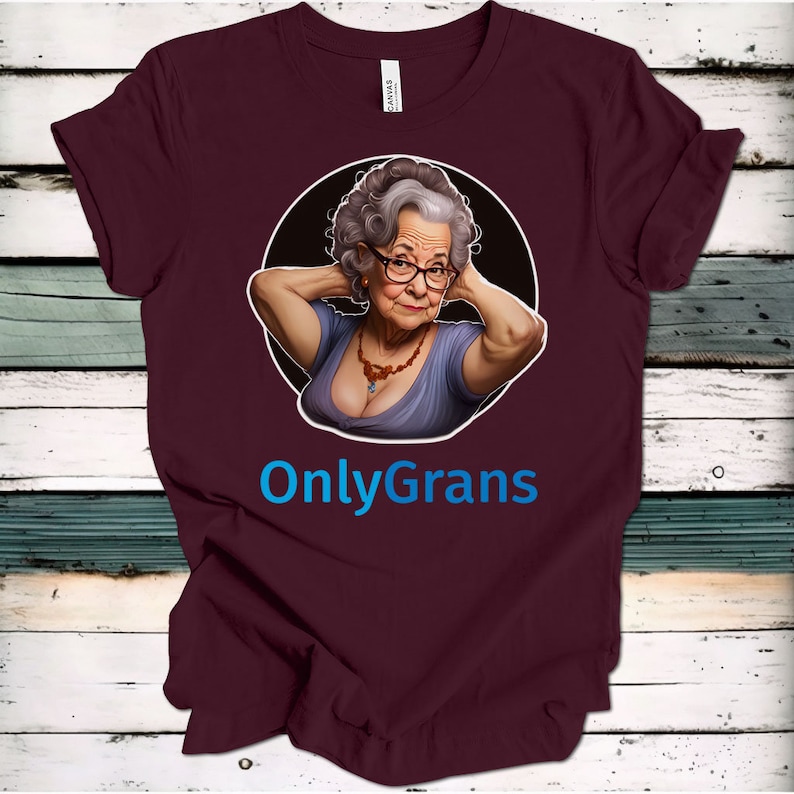 May include: A maroon t-shirt with a circular graphic of an older woman with gray hair wearing a purple top and a necklace. The text "OnlyGrans" is printed in blue below the graphic.