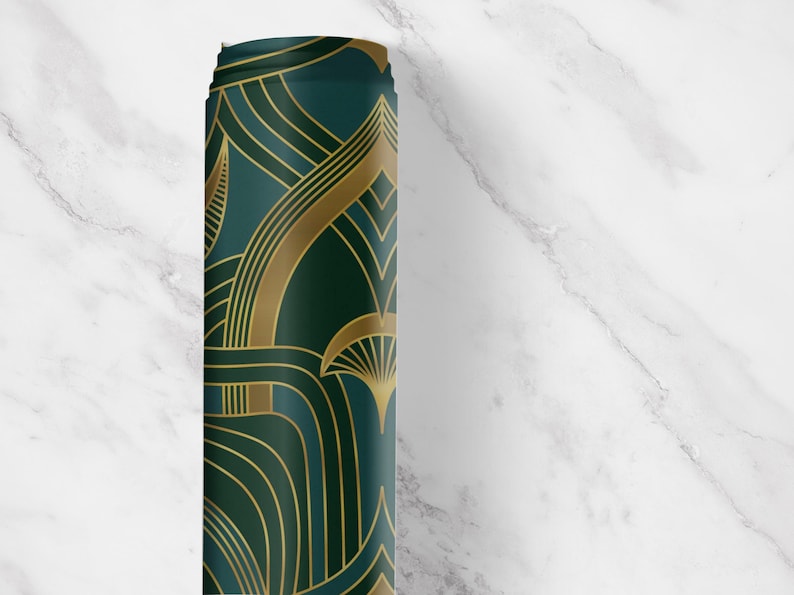 Close-up view of our Art Deco peel and stick drawer liner in a deep emerald green with metallic gold geometric fan and arch motifs. This vintage-inspired contact paper roll features bold 1920s style perfect for lining kitchen drawers, bar carts, shelves, or cabinets. The rich color and retro glam pattern add instant elegance and sophistication to any space. Ideal for renters and DIY decorators seeking classic Gatsby-era charm with easy application.