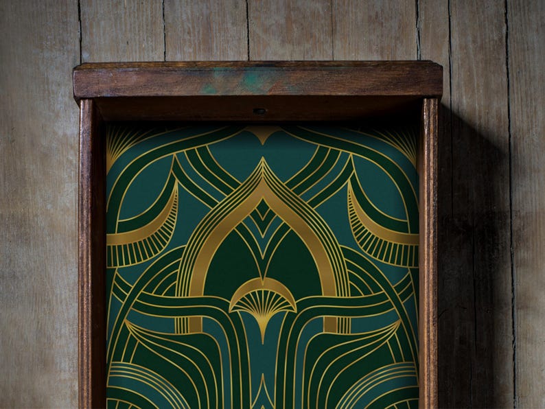 Dark green and gold Art Deco drawer liner featuring bold, curved geometric lines and fan motifs reminiscent of 1920s glamour. This peel and stick adhesive paper transforms drawers, shelves, or cabinets into stylish vintage-inspired spaces. With its luxe metallic gold accents and deep emerald background, this retro contact paper is perfect for jazz-age decor lovers seeking a touch of elegance in kitchens, vanities, or home bars. Great for renters and easy to apply.