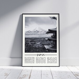 May include: Black and white photograph of Mount Fuji, a snow-capped mountain in Japan, with a traditional Japanese pagoda in the foreground. The text "JAPAN" is printed below the image with a brief description of the country.