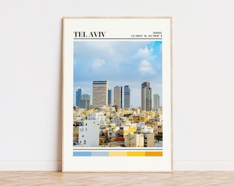 May include: A framed print of Tel Aviv, Israel, with a cityscape view of buildings against a blue sky with white clouds. The print includes the city name, coordinates, and a color palette of blue, yellow, and white.