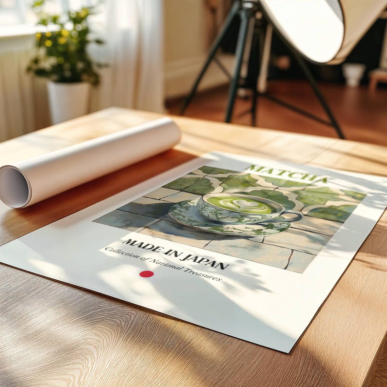 May include: A poster with a green and white illustration of a cup of matcha tea with a heart design in the foam. The poster has the text "MATCHA" and "MADE IN JAPAN Collection of National Treasures" on it.