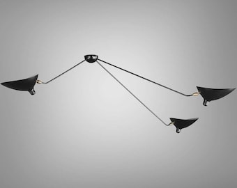 May include: A black three-arm ceiling light fixture with adjustable arms and black metal shades.