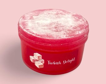 May include: A red plastic container of Turkish Delight candy, dusted with white powder. The container has a label with the words "Turkish Delight" and an illustration of the candy.