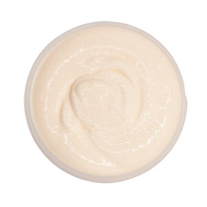 May include: A white, creamy, swirl-like substance in a clear plastic container. The substance is thick and smooth.