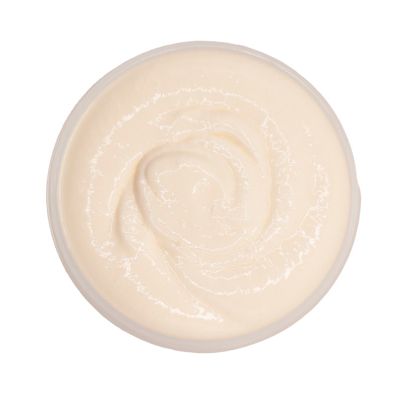 May include: A white, creamy, swirl-like substance in a clear plastic container. The substance is thick and smooth.