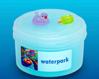 May include: A clear plastic container filled with blue slime. The slime has a small rubber ducky and a green popsicle floating in it. The container has a label that says "waterpark" and a picture of a waterpark with a slide and a life preserver.