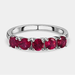 Peut inclure: Une bague en argent avec cinq pierres précieuses rouges serties en rangée.