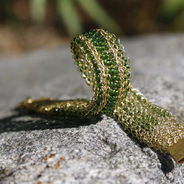 Hand-knitted gold-plated wire bracelet with green glass beads