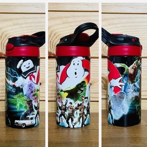 May include: A black and red water bottle with a Ghostbusters theme. The bottle features a graphic of the Ghostbusters characters and the Stay Puft Marshmallow Man.