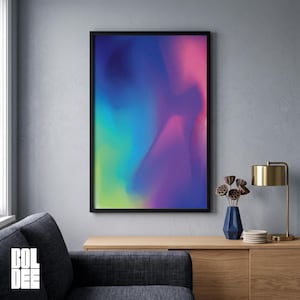 May include: A rectangular wall art print in a black frame featuring a vibrant abstract gradient of blended colors including deep blue, bright turquoise, lime green, and magenta pink, displayed on a wall above a wooden console table.